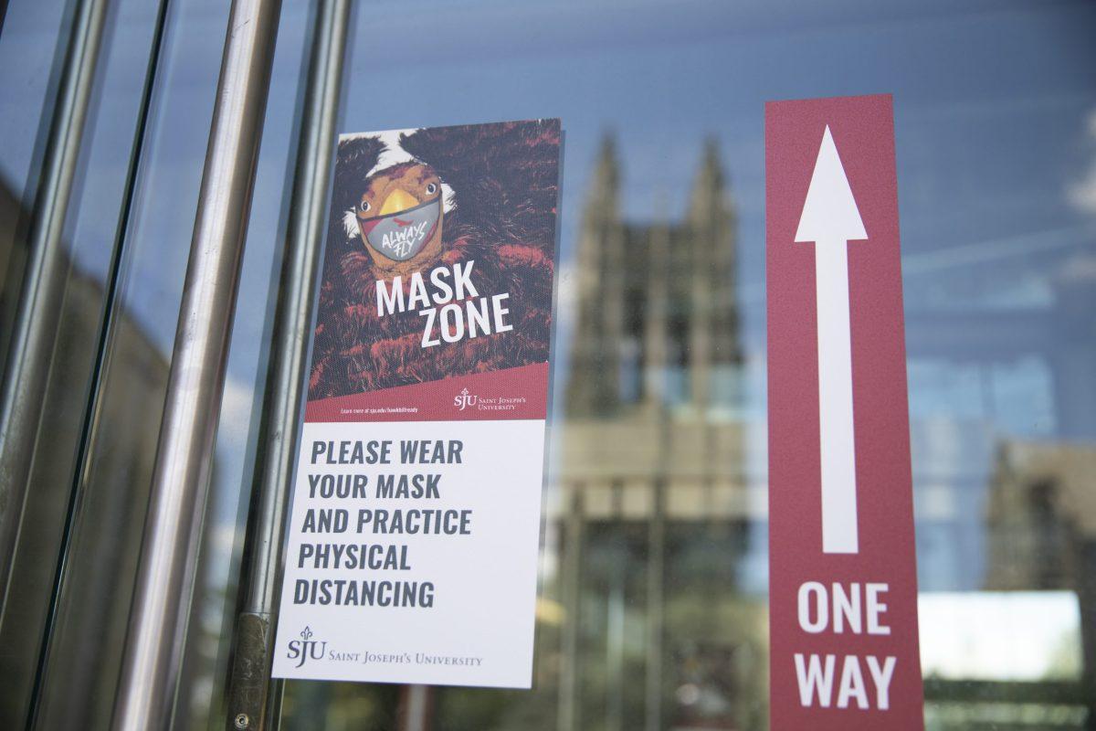 A sign reading mask zone hangs on the entrance to Drexel Library. PHOTO: MITCHELL SHIELDS 22/THE HAWK