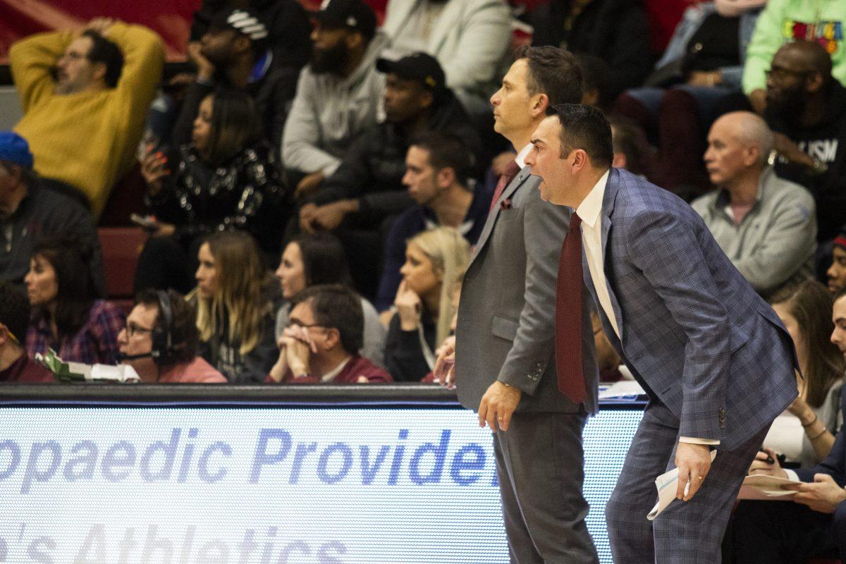Griffin on the sidelines of Hagan Arena with Head Coach Billy Lange. PHOTO: MITCHELL SHIELDS ’22/THE HAWK