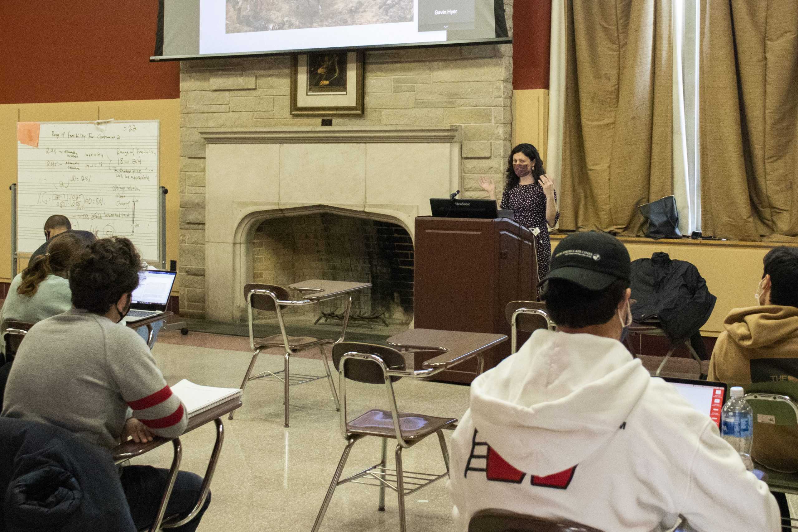 Elizabeth Morgan, Ph.D., teaches a class of socially-distant students in the Campion North Lounge. PHOTO: DANNY REMISHEVSKY ’23/THE HAWK