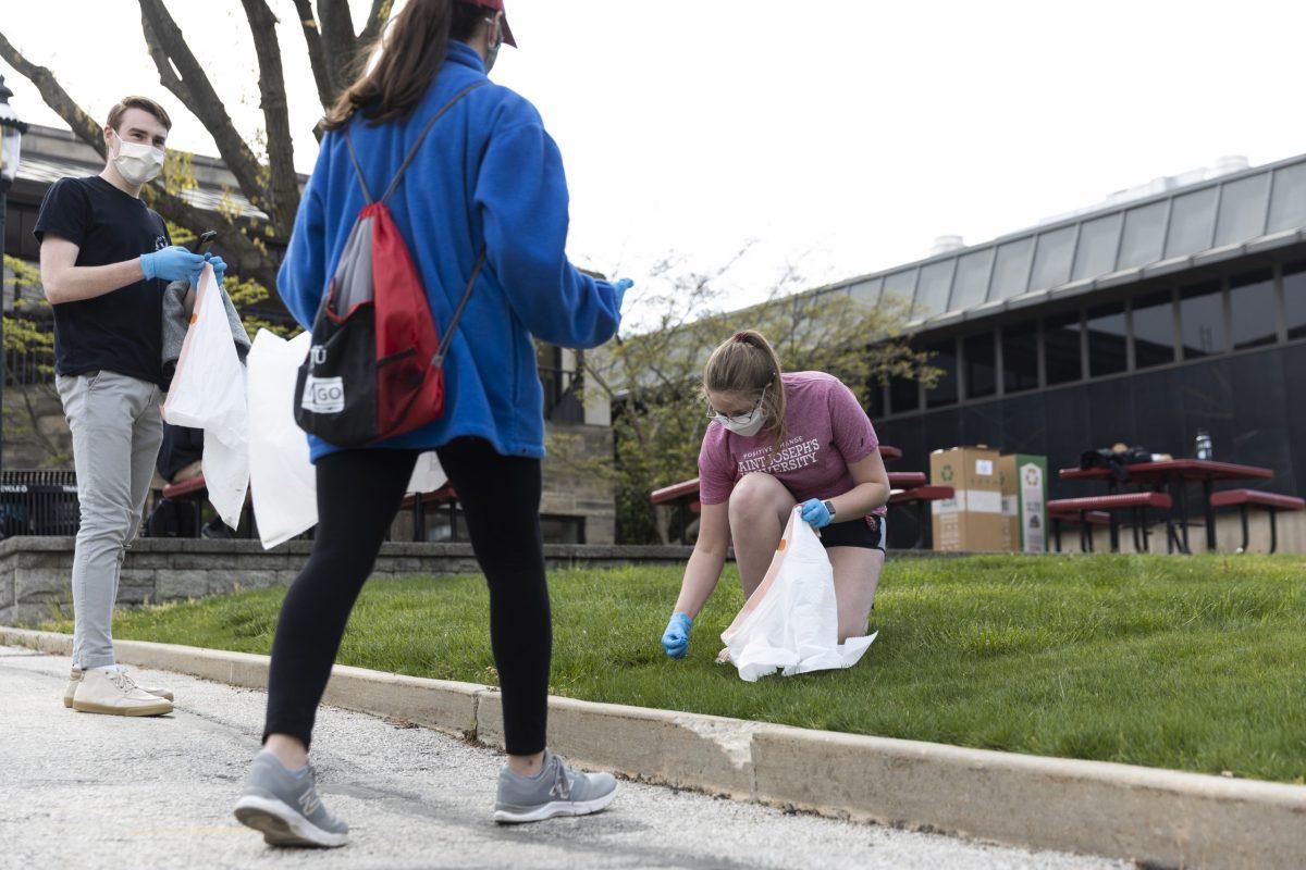 (left to right) Aidan Dowling 23, Teresa Scalanga 23 and Allie Miller 24 pick up trash outside of Campion Student Center on April 19 as a part of SJU Green Funds Campus Clean Up initiative. . 