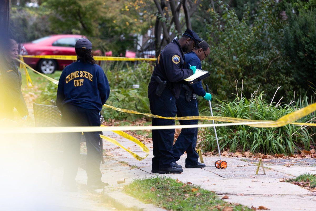 Philadelphia crime scene investigators gather evidence at the scene of fatal shooting on the 5700 block of Overbrook Avenue. PHOTO: MITCHELL SHIELDS 22/THE HAWK