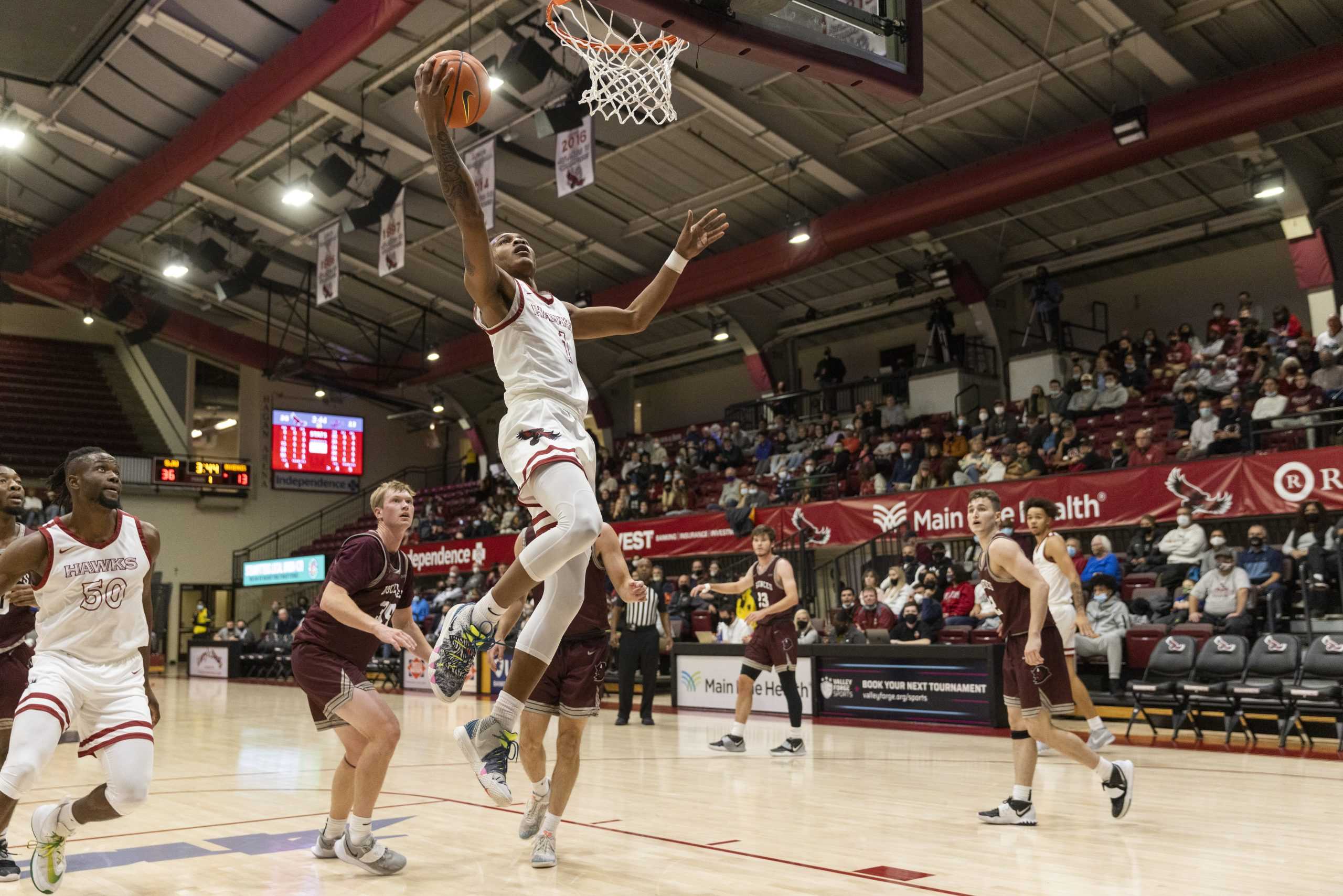 Junior guard Dahmir Bishop goes for a layup. Bishop finished the contest with five points. PHOTOS: MITCHELL SHIELDS '22/THE HAWK