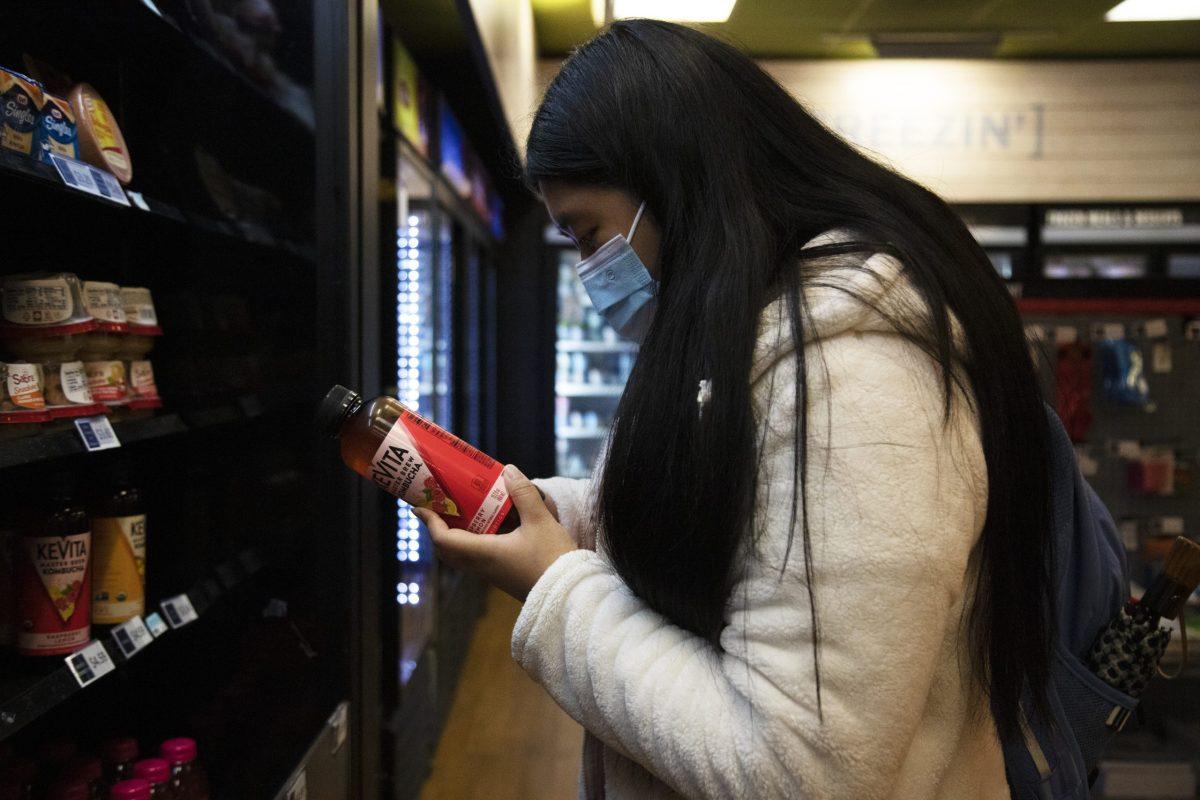 Rachel Kwok ’22 consciously considers healthier alternatives to sugary snacks while visiting the P.O.D. PHOTO: KELLY SHANNON 24/THE HAWK