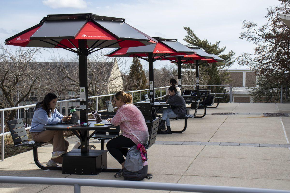 Students sit at the solar tables outside Drexel Library on Feb. 17. PHOTO: DEVIN YINGLING '22/THE HAWK
