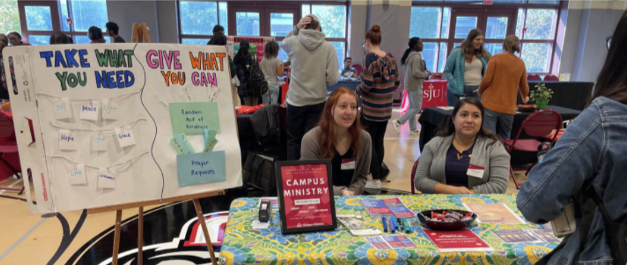 Giulianna Vullo and Alexis Larios, campus ministry associates, table at the
UCity Wellness Fair in the ARC on Nov. 4.
PHOTO: ALLIE MILLER ’24/THE HAWK