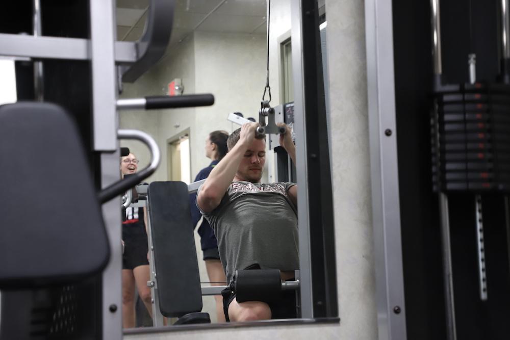 Michael Tansey ’25 using a lat pull-down at the Sourin Fitness Center. PHOTO: KELLY SHANNON ’24/THE HAWK