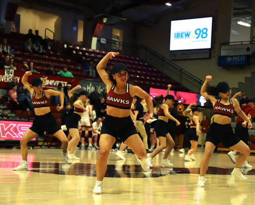 Alexia Luciano ’25, Maddie Ash ’25 and Mia Roa ’25 performing during halftime. PHOTO: KELLY SHANNON 24/ THE HAWK