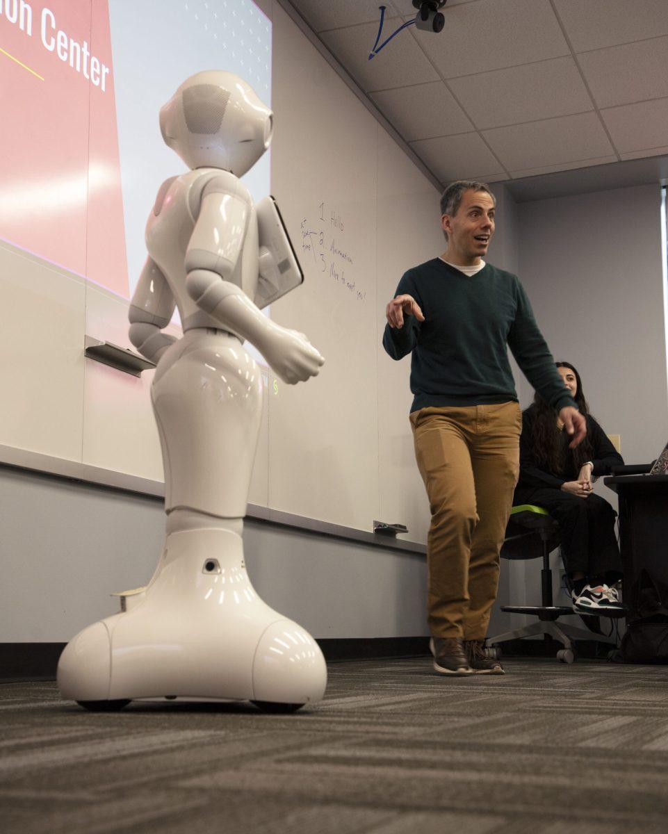 Marcello Balduccini, Ph.D., assistant professor of decision and system sciences, introduces Pepper the Humanoid Robot to students at a programming workshop March 4 at the Haub Innovation Center. PHOTO: KELLY SHANNON ’24/THE HAWK