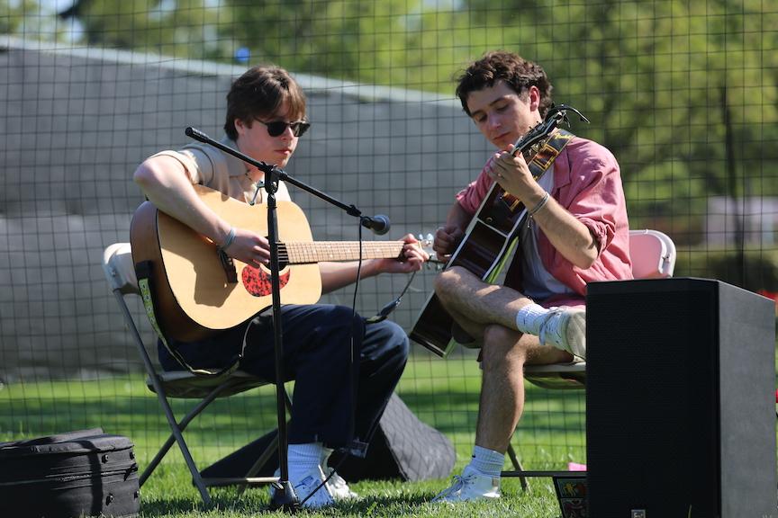 Colin Cooper ’25 and Dominic Rossi ’25 playing guitar at Art Fest April 20 on Curran Field.
PHOTO: MADELINE WILLIAMS ’26/THE HAWK
