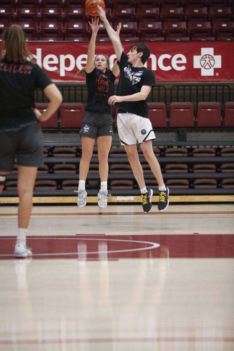Gabby Casey '27 warms up with practice player Sean
Beane '26.
PHOTO: MADELINE WILLIAMS ’26/THE HAWK