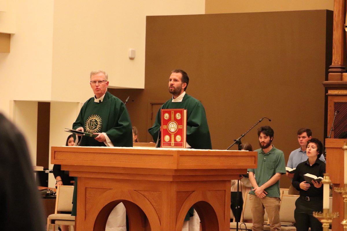 Douglass Ray, S.J., left, stands with Brian Strassburger, S.J., right, during his Sept. 17 homily.
PHOTO: MAX KELLY ’24/THE HAWK