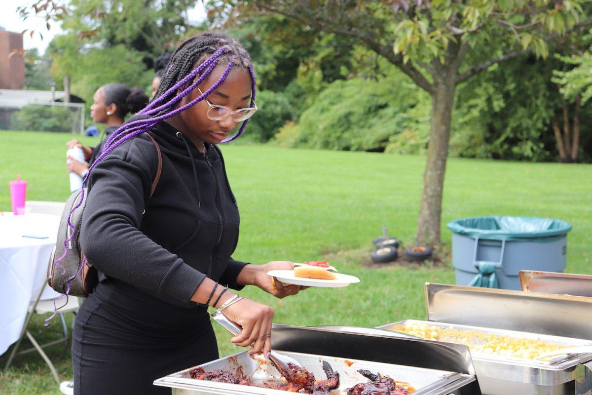 Taliyah Drummond-Cofer ’26 fills her plate at the Sept. 30 BSU barbecue. PHOTO: BEN VANELLI ’25/THE HAWK