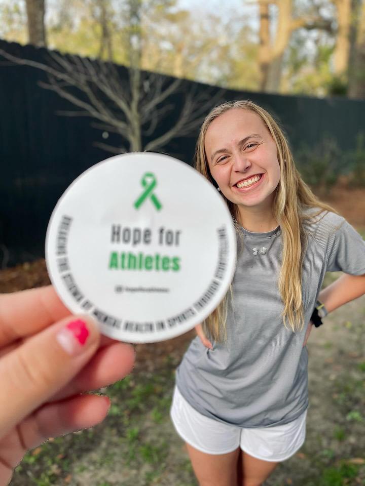Amanda+Dahlman%2C+the+founder+of+Hope+for+Athletes+poses+with+a+sticker+for+the+organiztion+which+provides%0Astudent-athletes+with+a+platform+to+share+their+mental+health+stories.%0APHOTO+COURTESY+OF+AMANDA+DAHLMAN