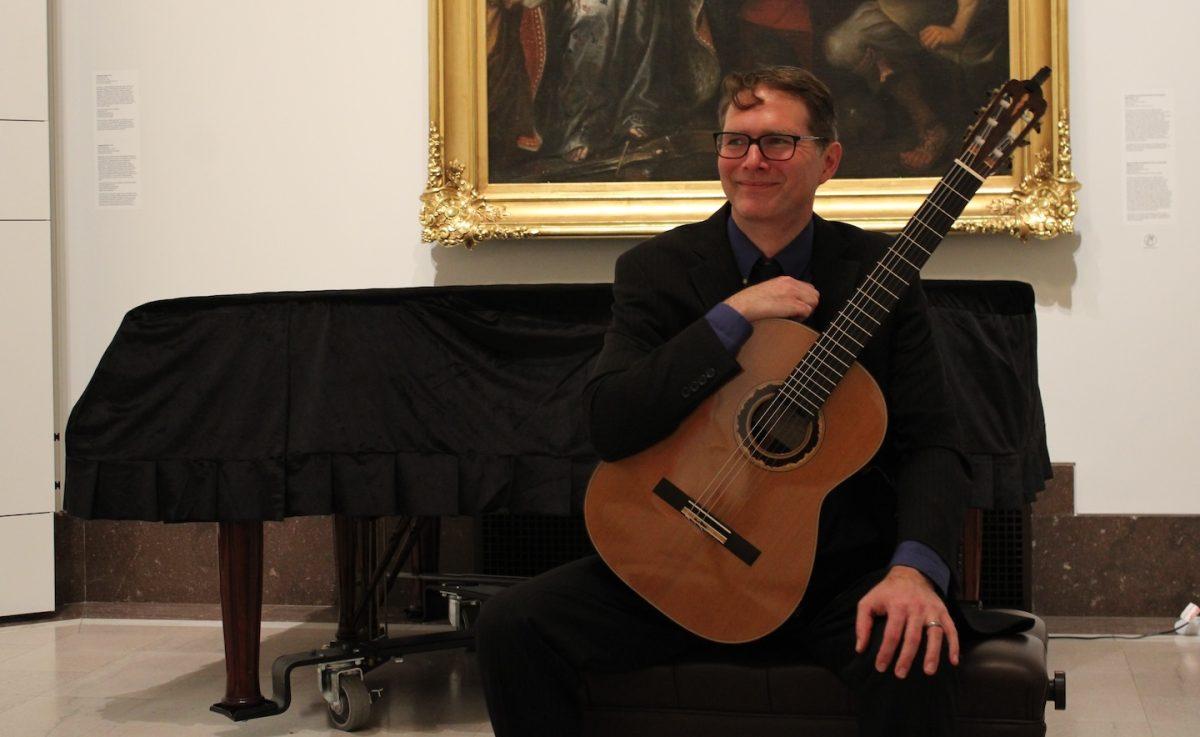 Guitarist Cale Hoeflicker, Ph.D., poses after performing at the Memorial Concert for Jeremy Harting at the
Frances M. Maguire Art Museum, Jan. 25. PHOTO: BEN VANELLI ’25/THE HAWK