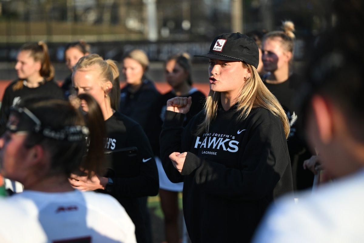 Photo of new Coach Katie Detwiler cheering on St. Joe’s women’s lacrosse team during their matchup against Maryland, Feb. 9