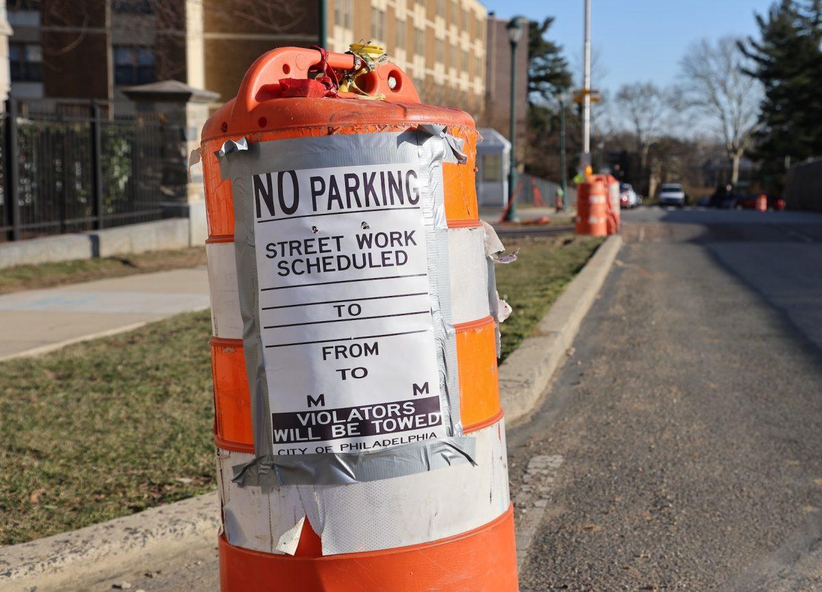 A cone on the curb of Cardinal Avenue with a sign reading “no parking” and “violators will be towed,” Feb. 25. PHOTO: MAX KELLY ’24/THE HAWK