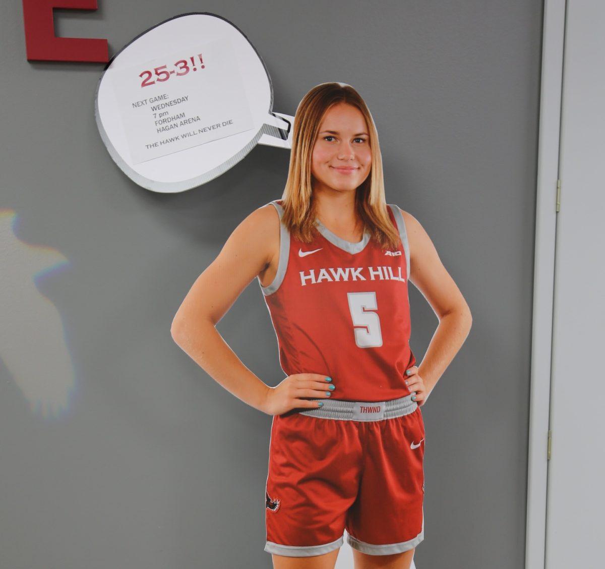 photo of a cutout of womens basketball player, which have been placed around Hawk Hill campus