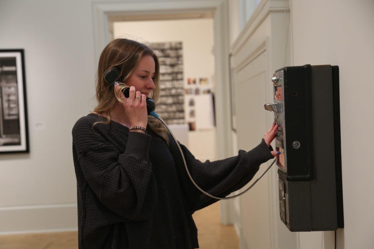 Photo of Kiera Donohue using a pay phone to symbolize only communicating with phone calls for a week