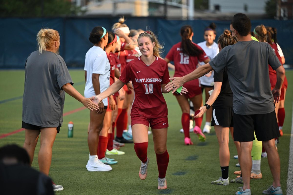 Senior Natalie Nevins runs out as the announcer calls her name for the starting 11 before the Aug. 27, 2023 Drexel game. PHOTO COURTESY OF NATALIE NEVINS