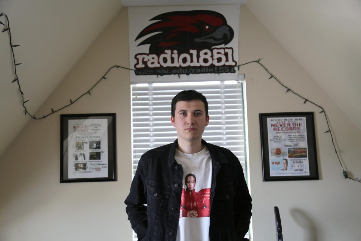 Parker Hayden ’25 poses at the Radio 1851 record studio in Simpson Hall, April 24. PHOTO: MADELINE WILLIAMS ’26/THE HAWK