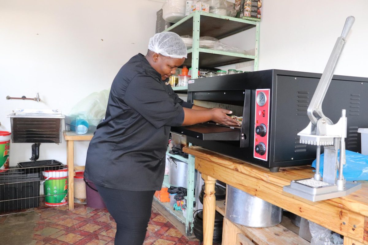 Makatleho (Anna) Maseko cooks a pizza at Kasi Pizza, her garage-turned-pizza-restaurant in Mautse, a township in the Free State province. PHOTO: MAXIMILIAN MURPHY 26/THE HAWK.