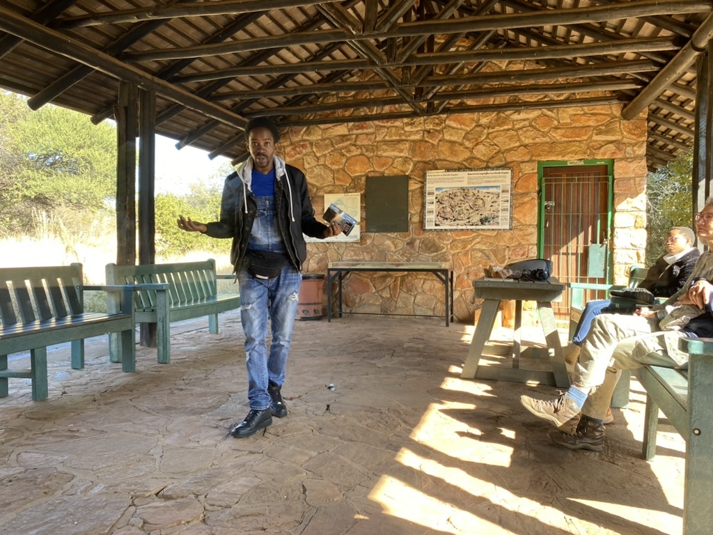 Poet Rabbie Serumula reads annotations left by his father in the back of a Louis LAmour novel as part of a monthly poetry series he helped to start at the Melville Koppies Nature Reserve. PHOTO: THE HAWK