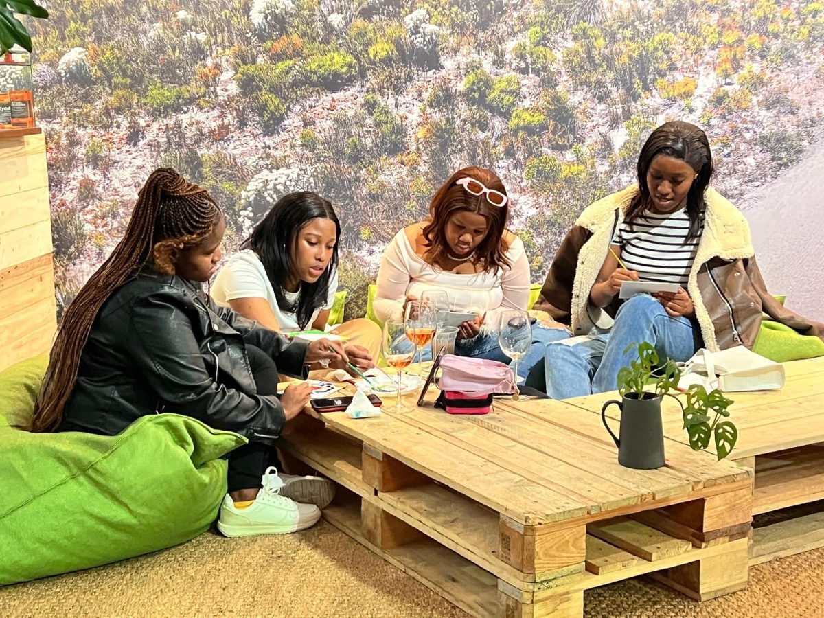 Amanda Cokile, Lilita Mkulungu, Sihle Mkulungu and Milisa Kuse (left to right) work on their paintings at a June 29 Cycling Friends Sip & Paint event. PHOTO: SHEKINAH DAVIS, M.A. 24/THE HAWK