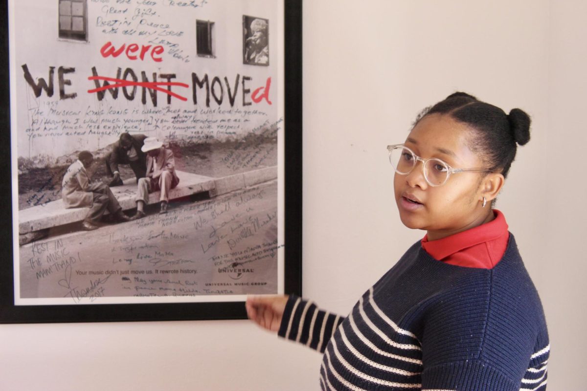 Jodi Lawerence, an administrator at the Sophiatown Heritage Centre, tells visitors about Sophiatown's history during a tour of the museum's rooms. PHOTO: SHAILA BHAYROO/THE HAWK