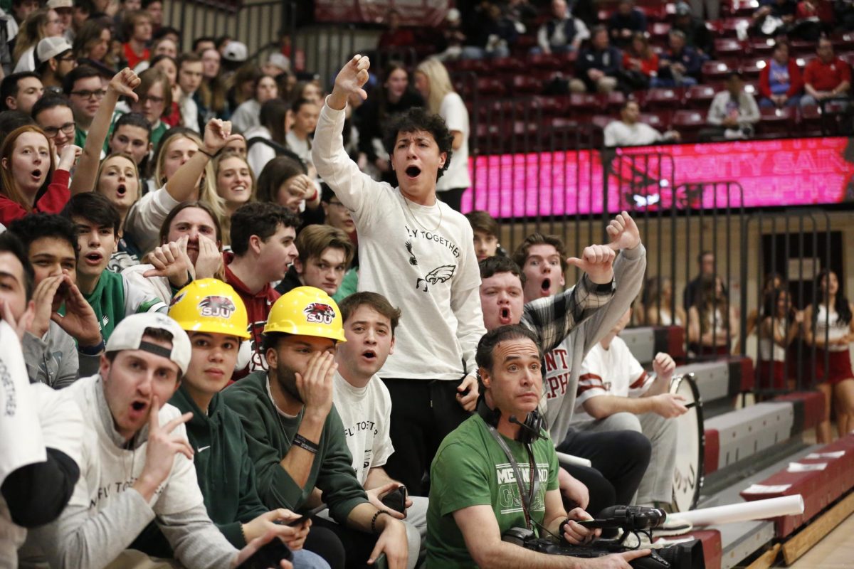 Members of the student section boo the Dayton men’s basketball team during warm ups, Feb. 6.