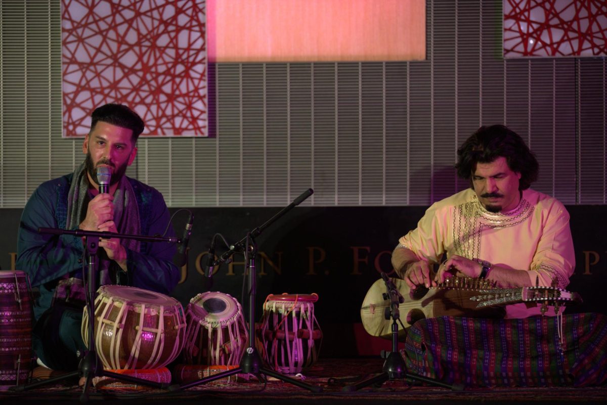 Musicians Salar Nader and Homayoun Sakhi address the audience and prepare for their next song in their Cardinal Foley Campus Center performance, Oct. 23. PHOTO: ZACH PODOLNICK ’26/THE HAWK