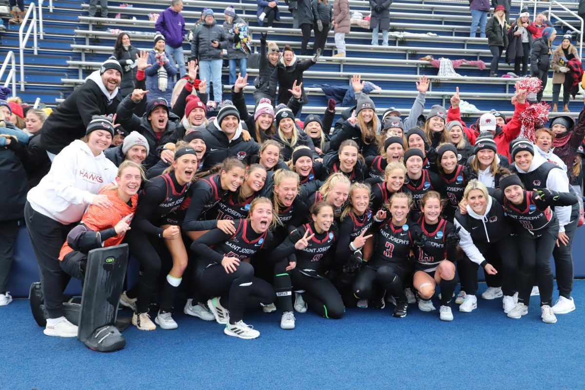 Field hockey poses for a team photo with fans and alumni after a 2-1 victory over North Carolina, Nov. 22, in Ann Arbor, Michigan, advancing to the NCAA Championship. PHOTO: MIA MESSINA '25