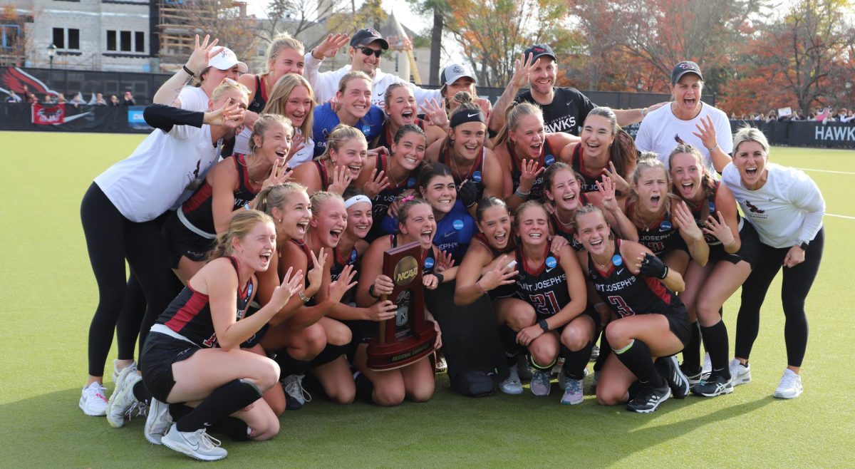 St. Joe’s field hockey poses with NCAA regional trophy after advancing to the Final Four, Nov. 17. PHOTO: MIA MESSINA ’25