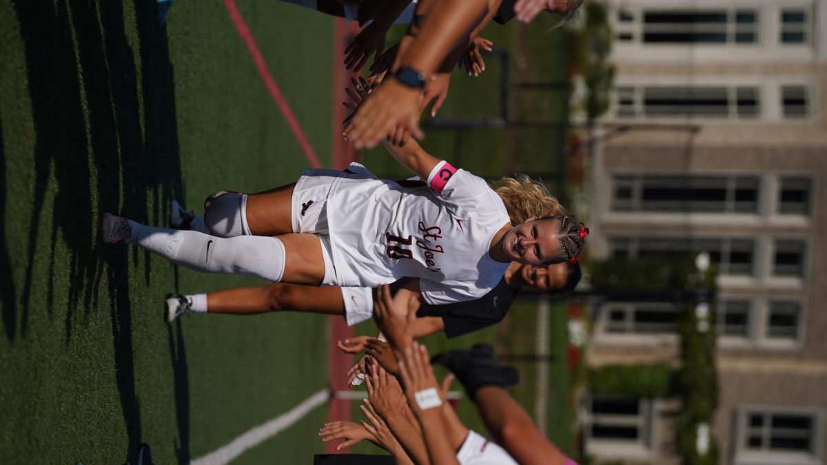 Natalie Nevins ’24, M.A. ’25 runs out after being announced for the starting lineup for St. Joe’s women’s soccer
game against Lafayette, Aug. 22. PHOTO COURTESY OF NATALIE NEVINS ’24, M.A. ’25/THE HAWK