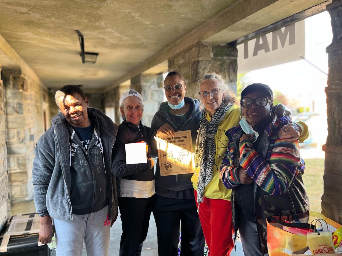 Nicole Williams (center) with Mt. Airy Fridge and Pantry volunteers at the fridge and pantry, located at the
Unitarian Univeralists church in Mount Airy. PHOTO COURTESY OF NICOLE WILLIAMS