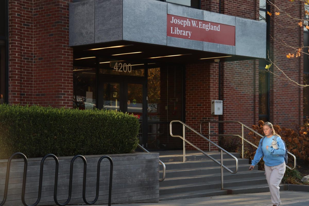 A student walks past England Library, Nov. 25. PHOTO: LUKE SANELLI ’26/THE HAWK