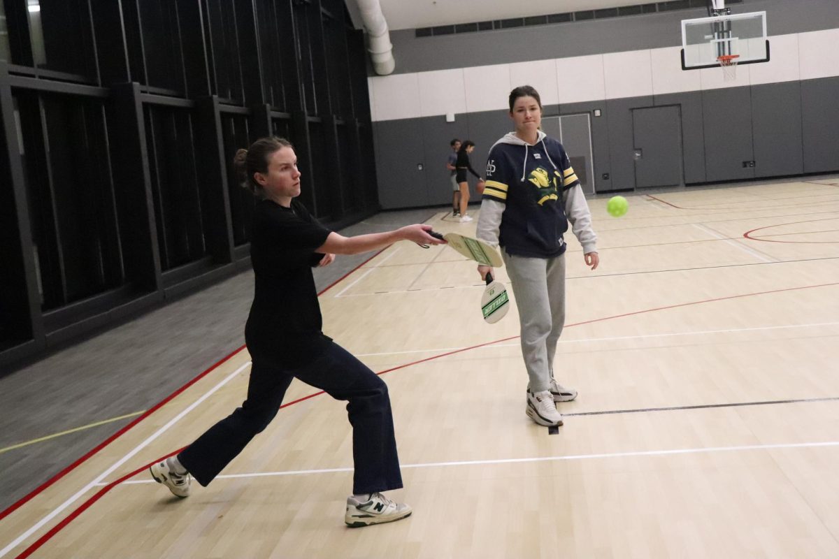 Bridget Carter ’25 returns a serve in a pickleball game, Dec. 2. PHOTO: ZACH PODOLNICK ’26/THE HAWK