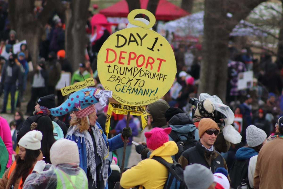 Protestors with signs gather at the People’s March in Washington, D.C., Jan. 18. PHOTO: LUKE SANELLI ’26/THE HAWK