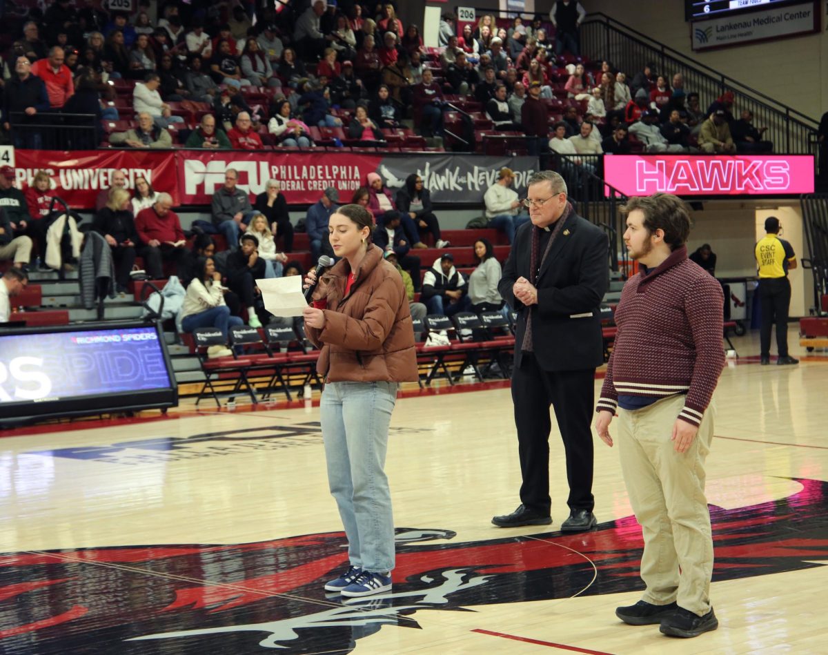 Sarah Mele ’27 and Jacob Phelps ’28 jointly won the annual alma mater singing competition held during the men’s basketball game, Feb. 22.
PHOTO: ZACH PODOLNICK ’26/THE HAWK