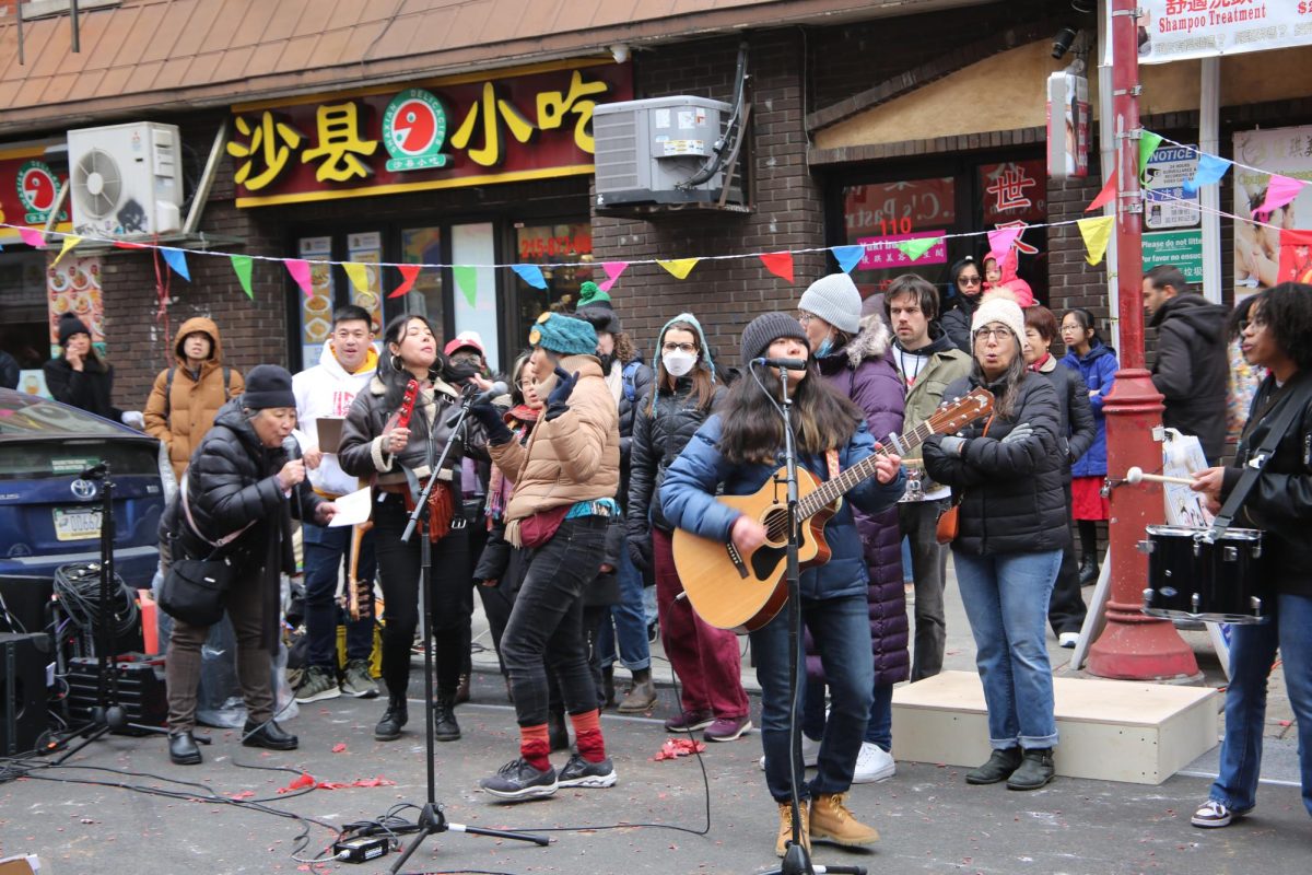 Activists perform celebratory songs next to Chinatown’s Friendship Gate in response to the canceled plans to build the 76ers arena, Feb. 2.