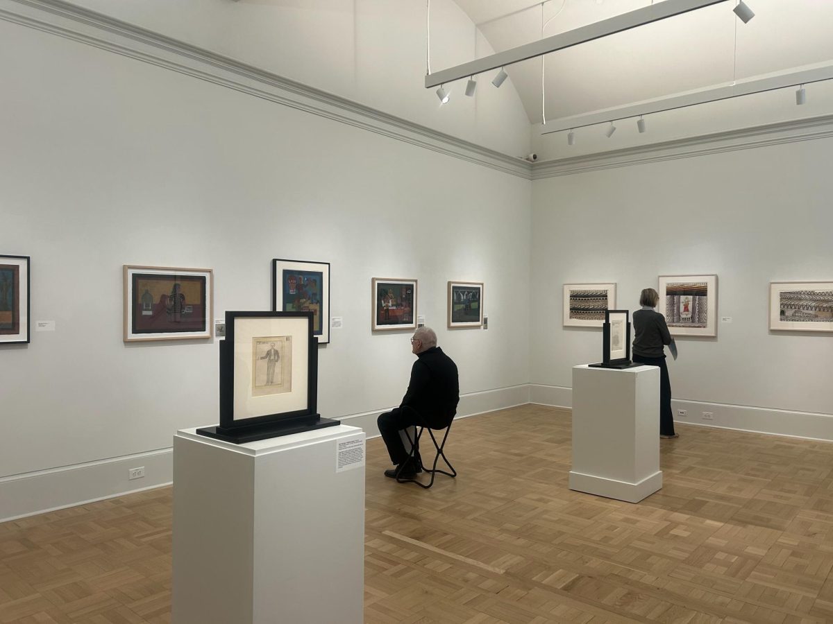 Community members look at art in the “Make or Break: Creativity as an Act of Survival” exhibit in the Maguire Art Museum, Feb. 20.
PHOTO: TESS MARGIS ’26/THE HAWK