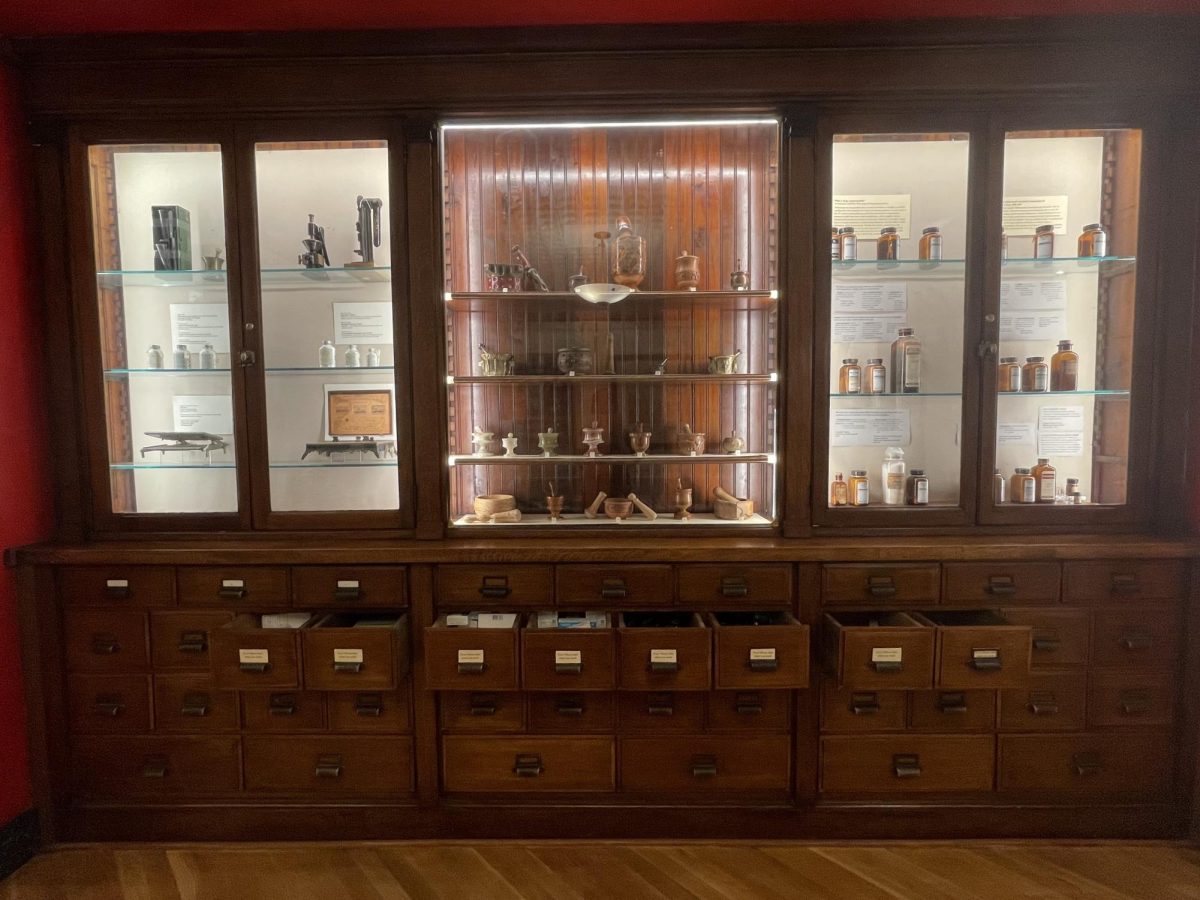 A gallery installation view showing drawers of free public health products in the Marvin Samson
Pharmacy Museum. PHOTO COURTESY OF EMMA GUNUEY-MARRS