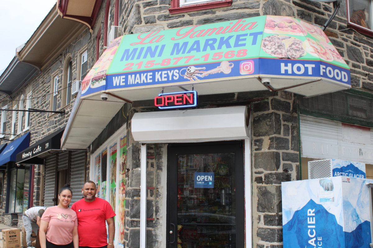 Rosanna (Rossy) Fernández and Junior Guaba, owners of La Familia Mini Market, pose in front of their store. PHOTO: BEN VANELLI ’25/THE HAWK