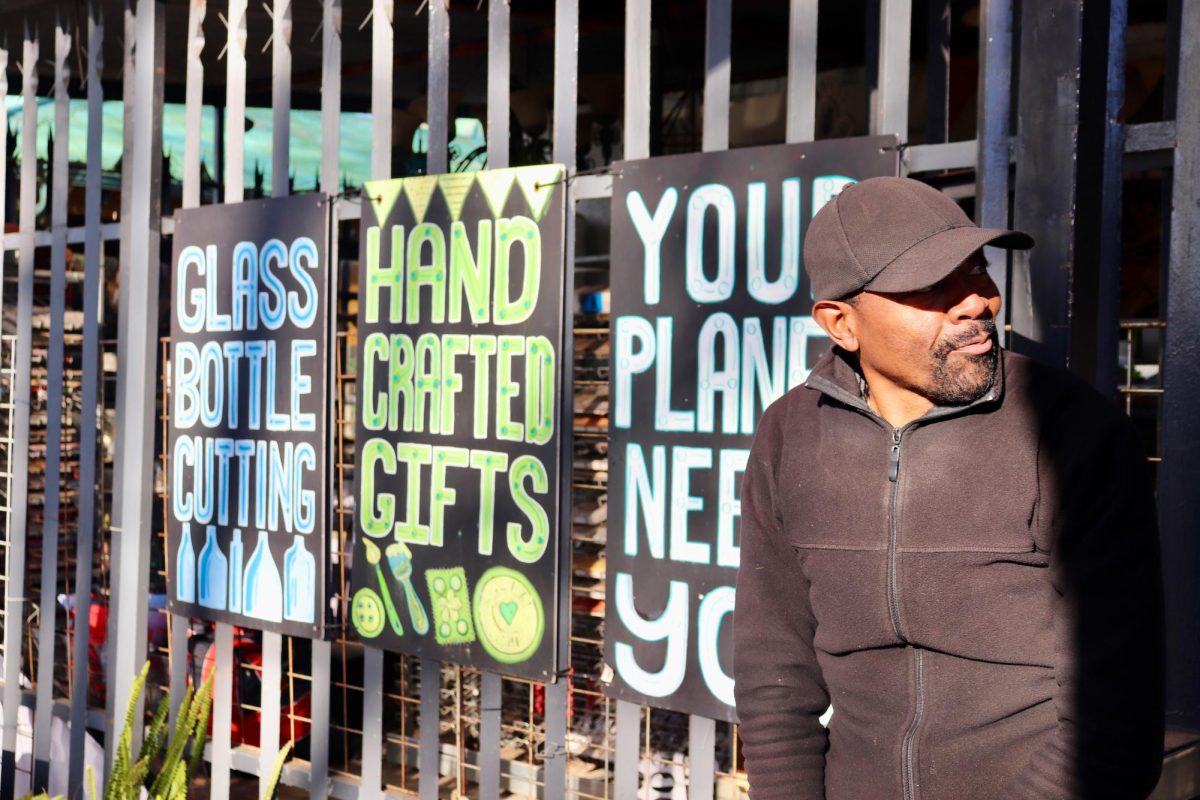 ay Maoko, Upcycle's community trainer and store manager, stands outside the Johannesburg-based organization's store, which promotes sustainability through upcycled products. PHOTO: HELENA SIMS/THE HAWK
