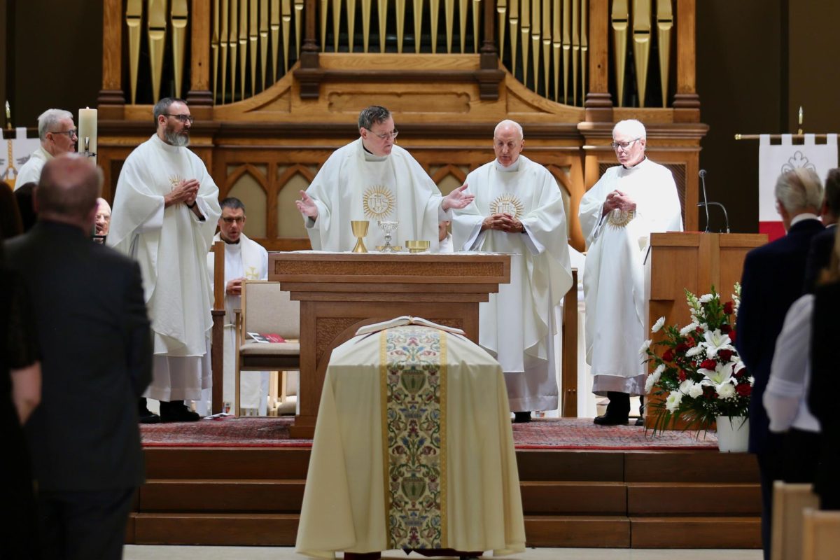 Daniel Joyce '88, S.J., presides over the July 23 funeral mass for 
Nicholas S. Rashford, S.J., 25th president of St. Joe's. The mass was held in the Chapel of St. Joe's. PHOTO: SAHR KARIMU