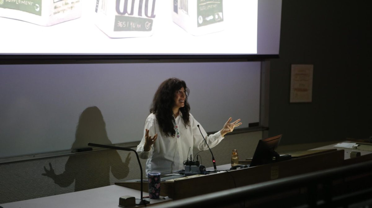 Artist Teresa Cervantes, MFA, associate professor of sculpture at the University of North Carolina School of the
Arts, presents a slideshow of her artwork at the Marvin Samson Museum for the History of Pharmacy Sept. 18.
PHOTO: DEE ALABEDE ’26/THE HAWK
