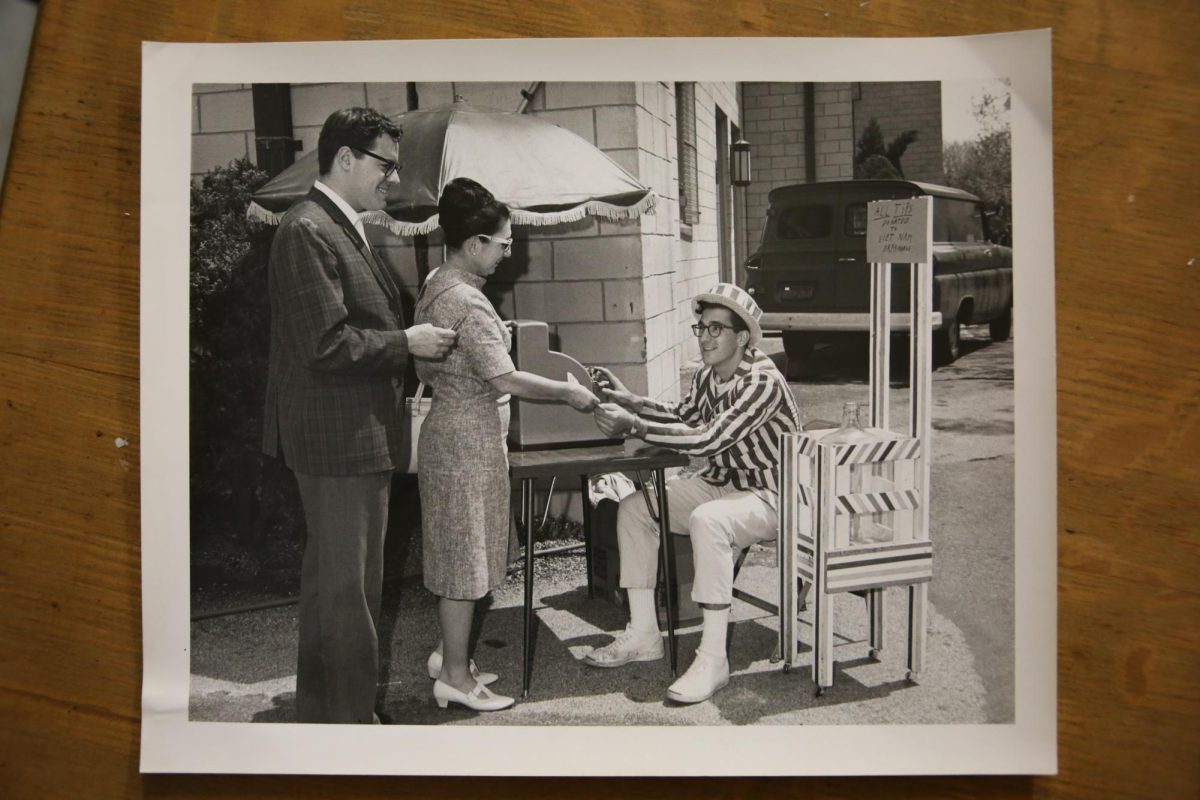 A student accepts donations on behalf of Project Vietnam, raising money those orphaned by the Vietnam War. PHOTOS: ZACH PODOLNICK ’26/THE HAWK