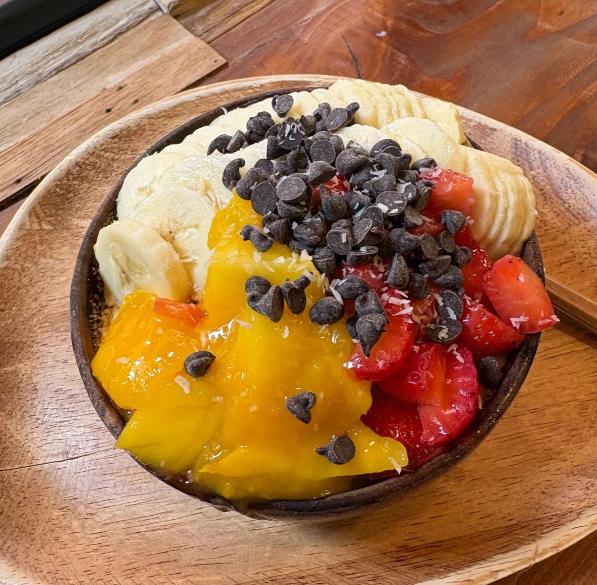 The Passion Bowl from Amazonia Açaí comes with açaí base, passion fruit cream, cookie pieces, chocolate chips, strawberry, banana, mango and coconut. PHOTO: LISBETH URENA ’27/THE HAWK