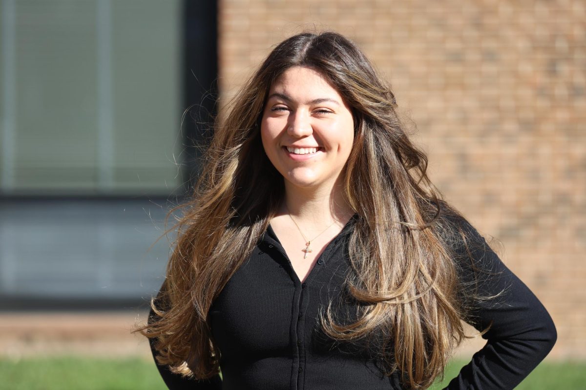 Alivia Oreo ’27 poses with her 1990s blowout, characterized by big volume and soft curls.