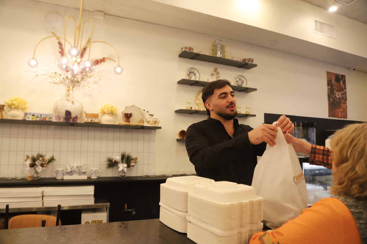 Muhammed Emenet gives a community member a Thanksgiving meal at Jersey Kebab's new Collingswood location, Nov. 27. PHOTO: GRACE O’MEARA ’27/THE HAWK