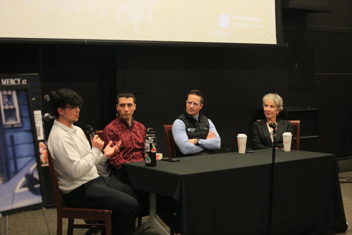 Left to right: Ean Hudak ’26, Fredy Abboud ’25, Dan Tarrant, filmmaker, and Dianne Hoffman, executive director of Mother of Mercy House, answer questions during panel discussion of the film “Mercy at the Gates” in Forum Theater Feb. 16. PHOTO: ZACH PODOLNICK ’26/THE HAWK